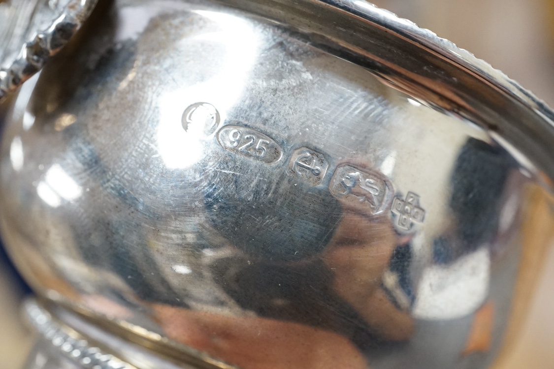 A modern silver wine funnel, with shell thumbpiece, L.J. Millington, Birmingham, 2000, 13.4cm, together with a small silver pedestal cup, three assorted sterling wine labels and three other wine labels including two plat